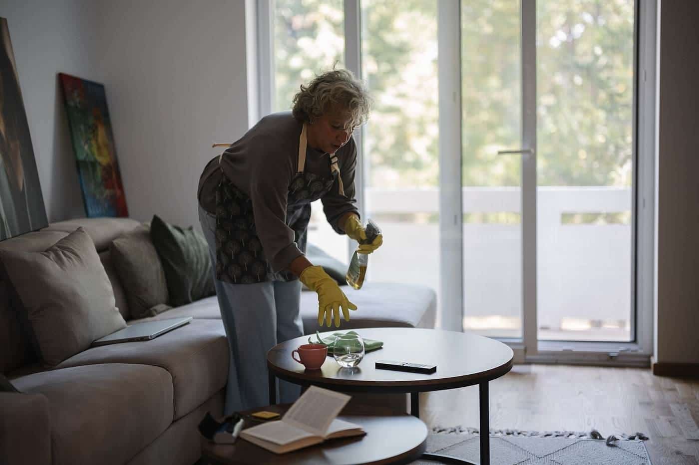 A woman cleaning a living room
