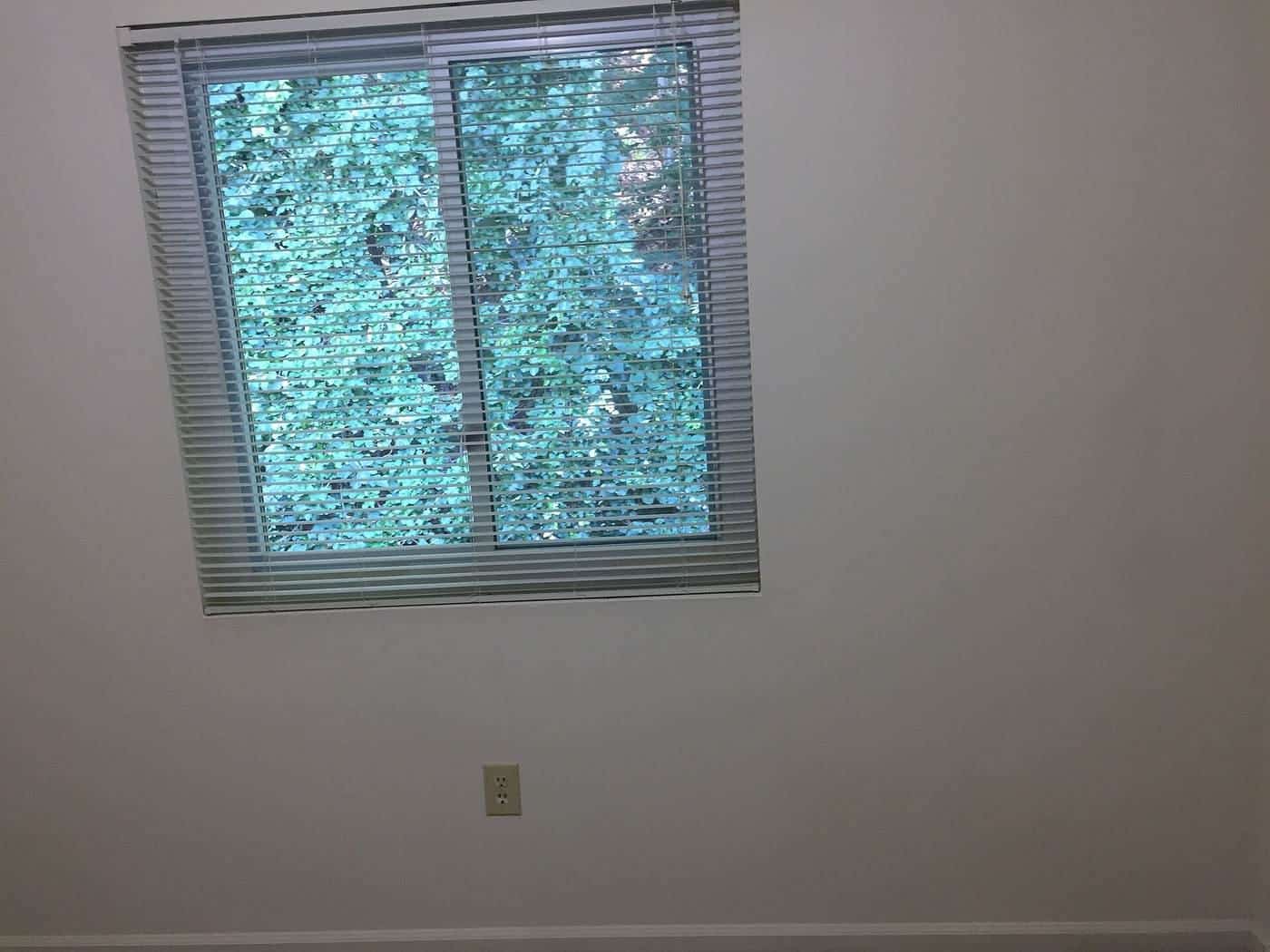An empty room with a window, ready for a final inspection