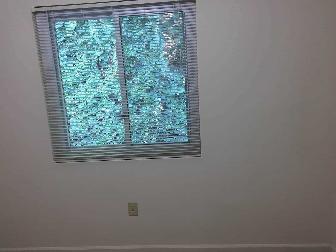 An empty room with a window, ready for a final inspection